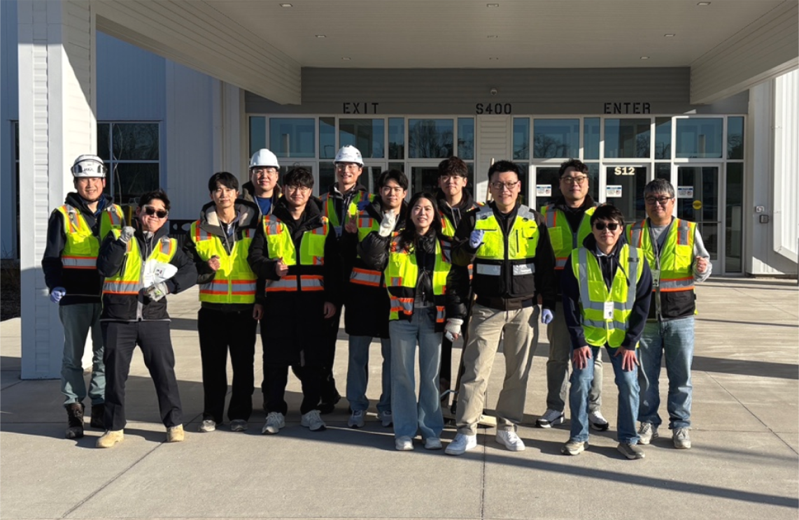 Group photo of team members in Lansing, MI after cleanup. 